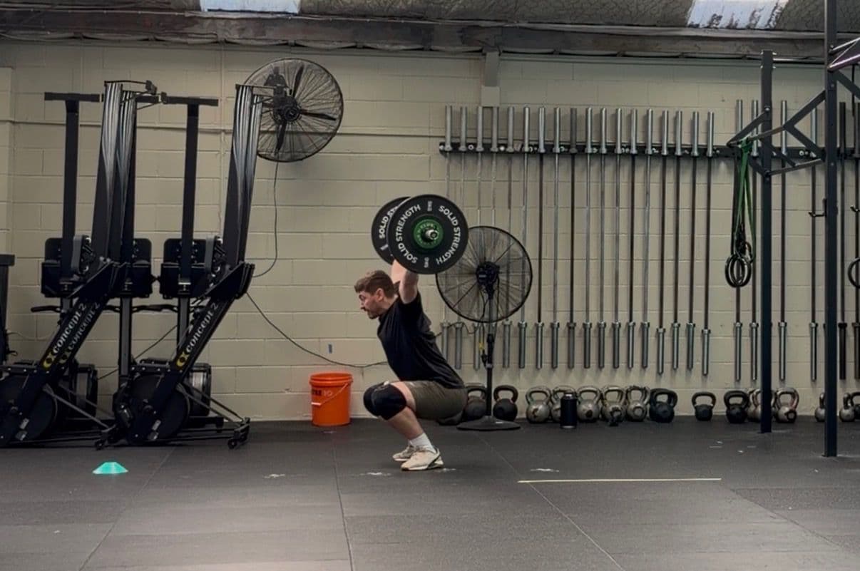 Julz Halkyard, Owner and Head Coach at CrossFit Hibiscus Coast, doing an overhead squat