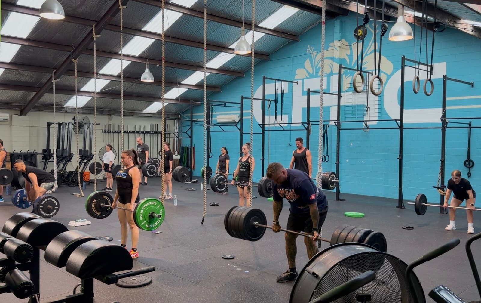 Members lifting barbells during a coached group class at CrossFit Hibiscus Coast