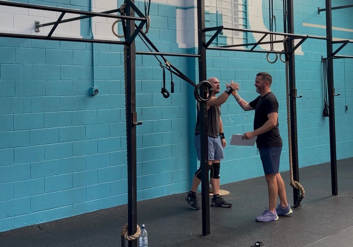 Two members fist-bumping after a workout at CrossFit Hibiscus Coast